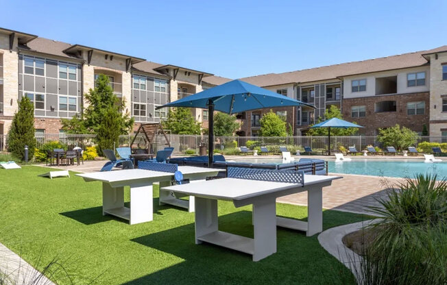 A poolside area with tables and umbrellas.