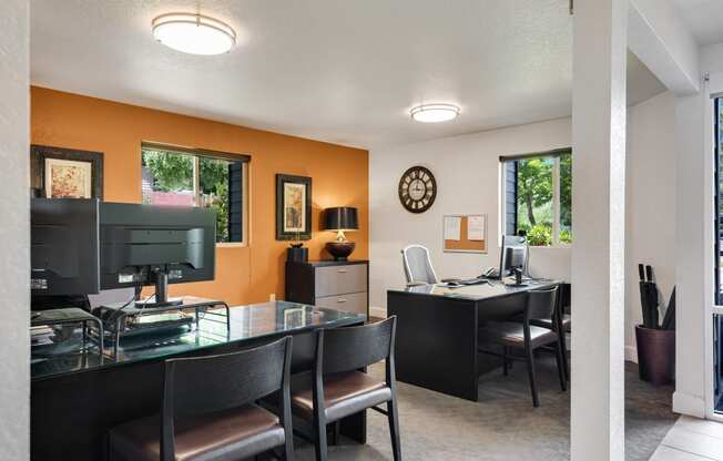 a dining room with a glass table and chairs and a desk with a computer at Eagles Landing Apartments, Everett, WA