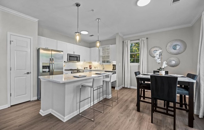 a kitchen with an island and a table with chairs