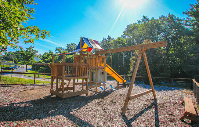 Playground with swing at Village Royale Apartments