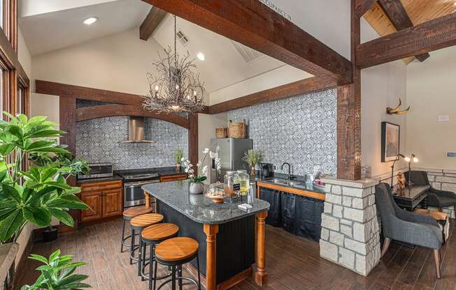 a kitchen with a long island with stools and a fireplace