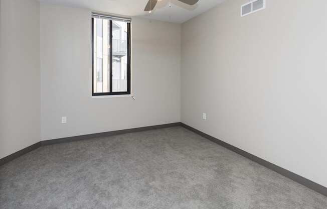 Spacious living room with neutral walls and ample natural light.