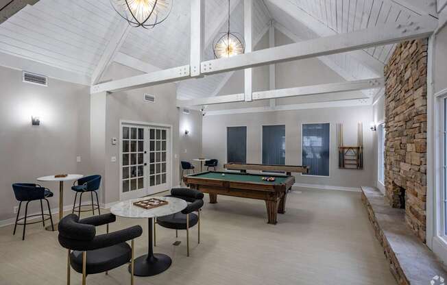 A room with a pool table and a billiard table.