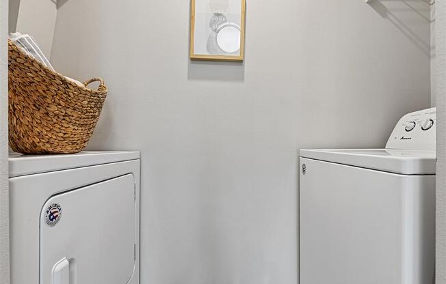 model home laundry room with full size washer/dryer