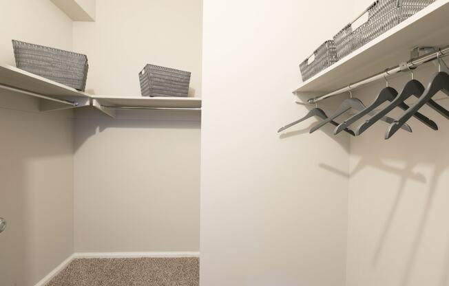 a walk in closet with chairs and a shelf on the wall at Apartments at Denver Place, Colorado, 80202
