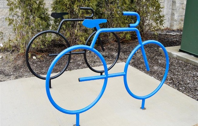 a blue bike rack with two bikes on it