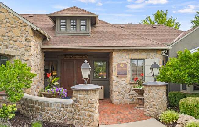 a home with stone walls and a brown door