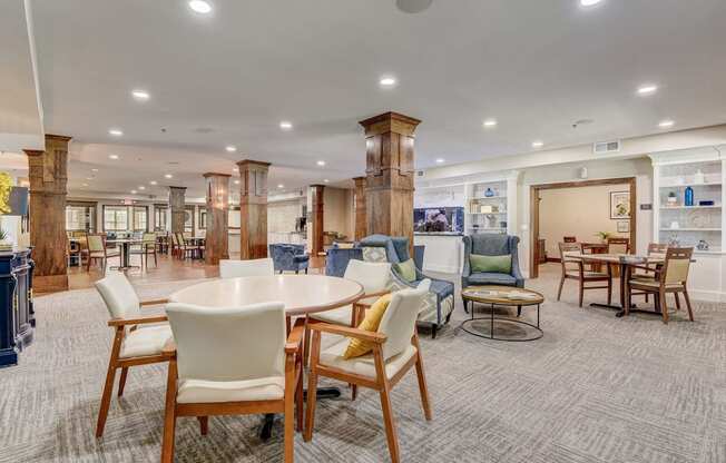 a large room with tables and chairs in a lobby