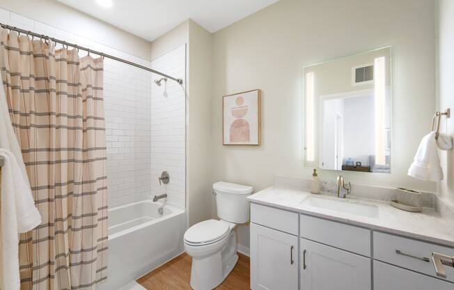 a white bathroom with a shower toilet and sink