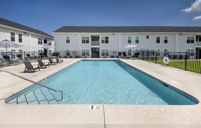 our apartments have a resort style pool with chairs and umbrellas