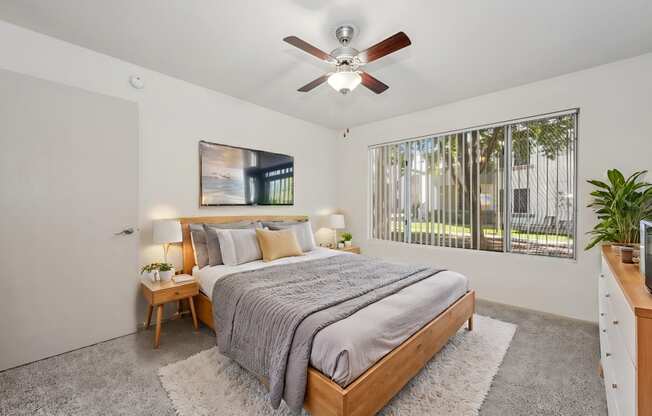 a bedroom with a bed and a ceiling fan