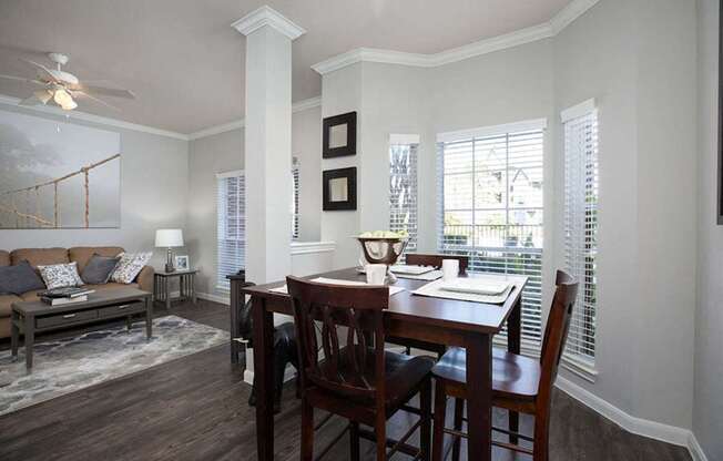 a dining room and living room with a table and chairs