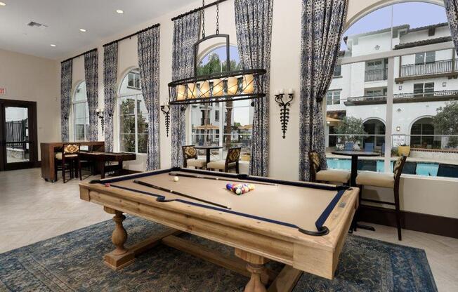 a pool table in a living room with a patio