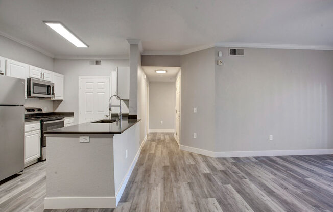 a kitchen with a stove top oven next to a refrigerator