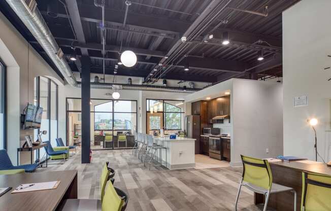 an open concept office space with a kitchen and dining area