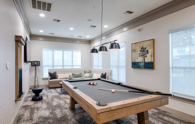 Recreation room with pool table and windows
