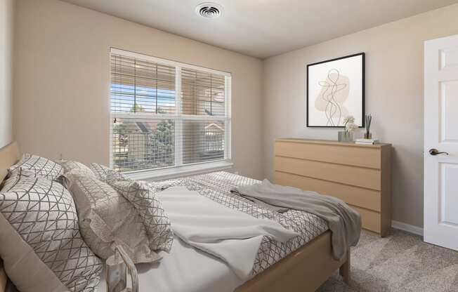 an empty bedroom with a bed and a window