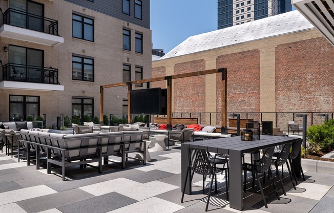 Outdoor rooftop lounge with firepits, grilling & outdoor dining space.