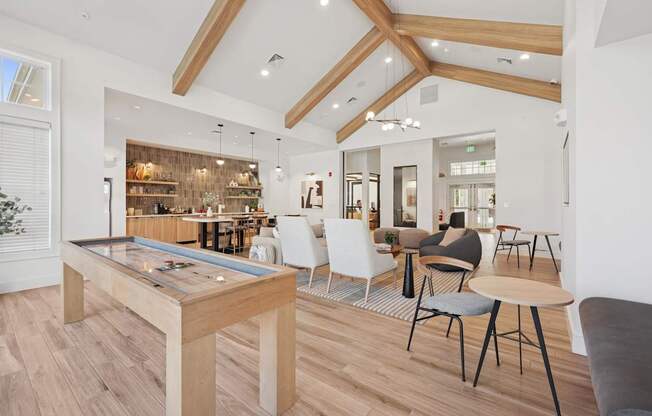 A modern dining room with a pool table and a bar area.