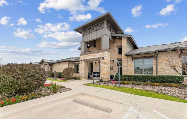 A modern house with a stone facade and a large front yard.