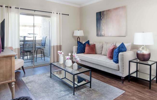 a living room with a couch and a glass coffee table