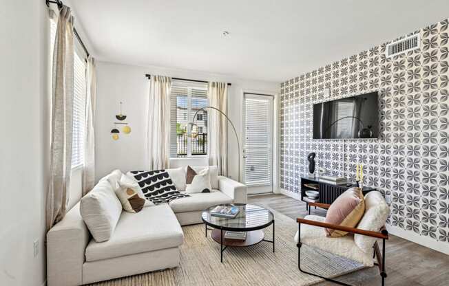 a living room with a couch and a chair and a television