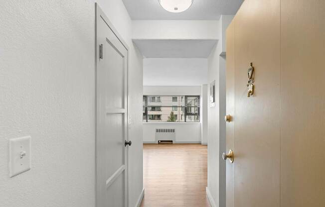 a view of a living room from a hallway with a door open