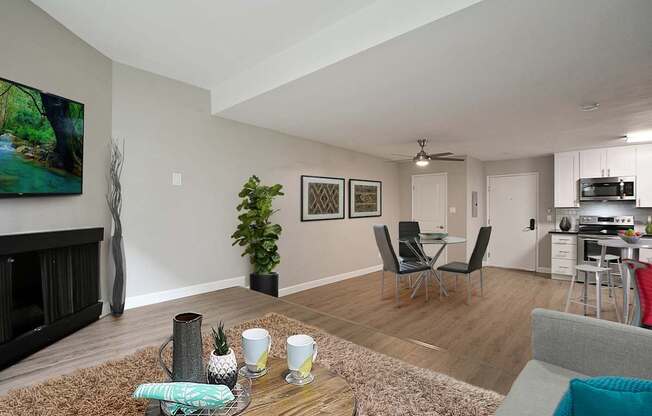 Den with cozy fireplace, wood inspired floors