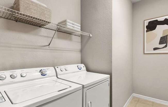 A white washing machine and dryer in a laundry room.