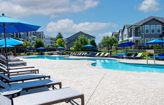 Lounge chairs on the sundeck next to swimming pool