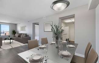 A modern dining room with a table set for two.