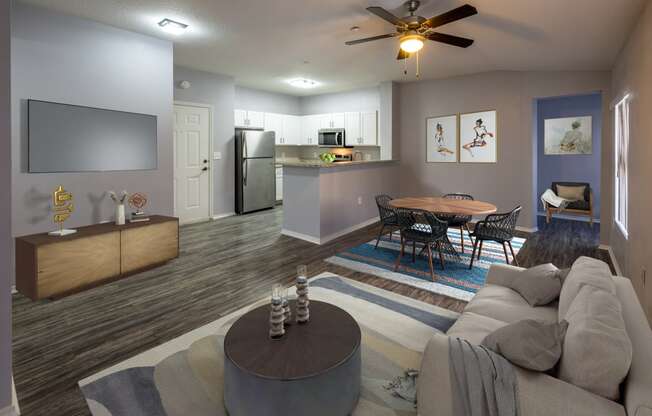 a living room with a couch and a table and a kitchen