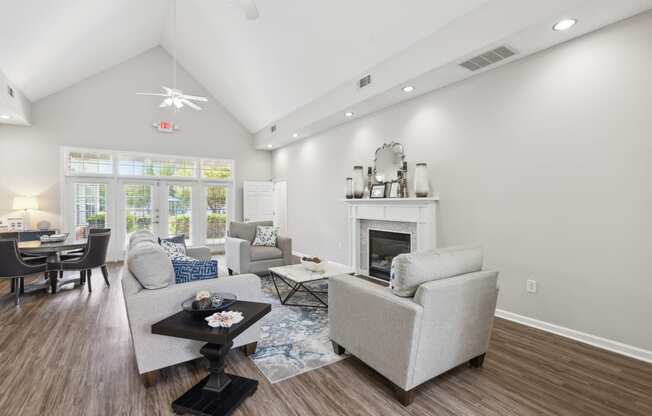 a living room with couches and chairs and a fireplace