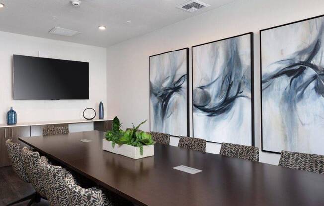 a conference room with a long table and a tv