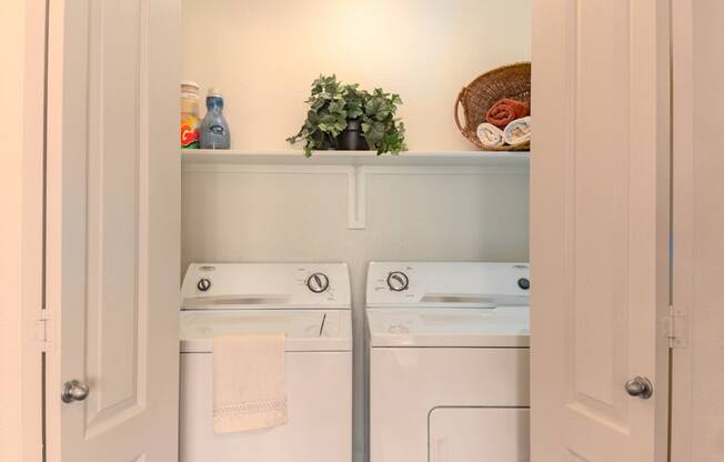 a small laundry room with a washer and dryer
