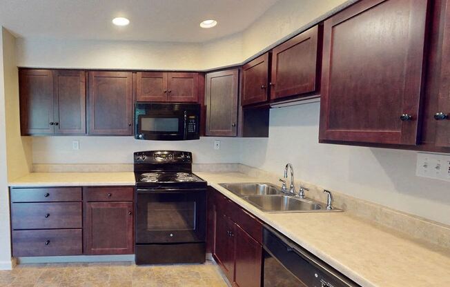 a kitchen with wooden cabinets and a sink