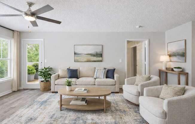 A living room with a couch, chairs, and a coffee table.