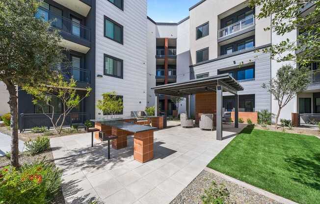 A modern outdoor patio area with a table and chairs.