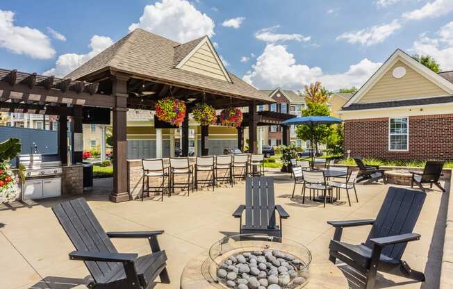 an outdoor patio with chairs and tables and a pavilion