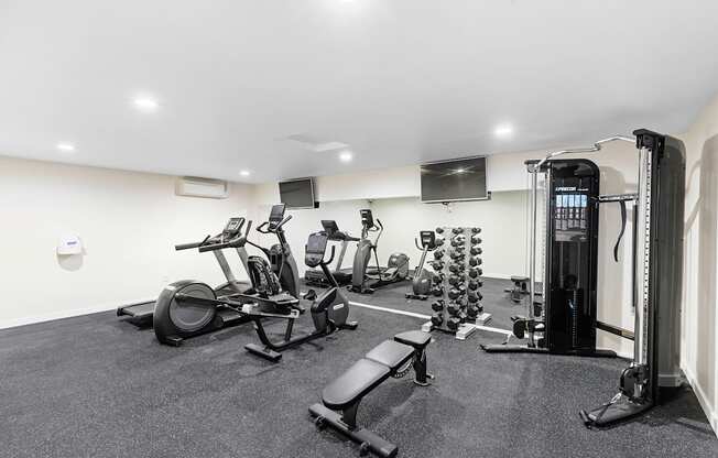 a gym with cardio equipment and a flat screen tv  at Casa Blanca Apartment Homes, Washington, 98204