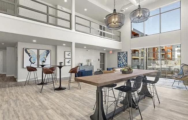 A modern dining room with a wooden table and chairs.