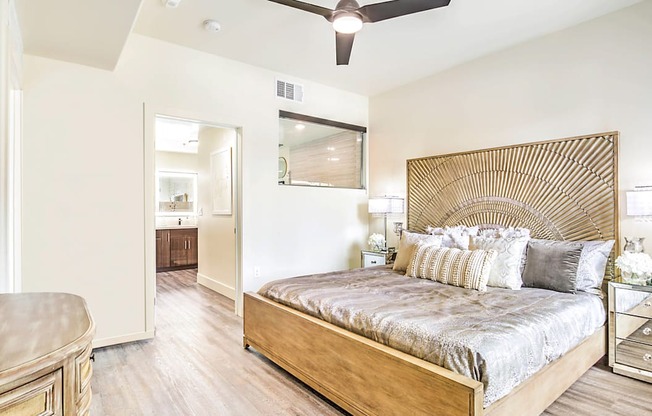 a bedroom with a large bed and a ceiling fan