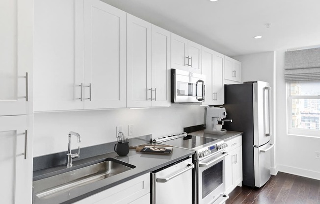 Kitchen with appliances at 65 Bay Street, Jersey City