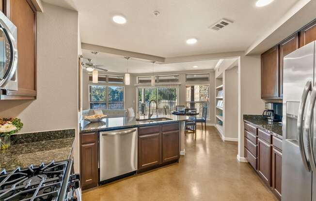 A modern kitchen with a large island and stainless steel appliances. at Bridge at Heritage Woods, Texas