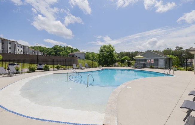 our apartments have a large pool with chairs and tables