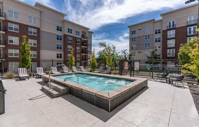 our apartments have a resort style pool with lounge chairs and an apartment building