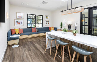 a living room with a couch and a kitchen with a table and chairs at La Jolla Blue, San Diego, CA