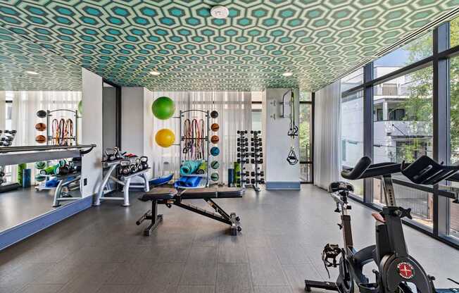 A gym with a green ceiling and exercise equipment.