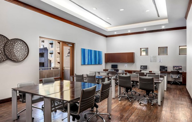 A conference room with a long table and chairs.
