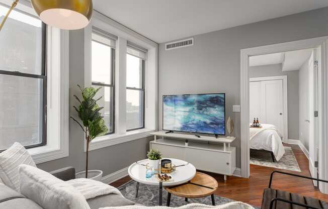 a living room with a couch and a table and a tv